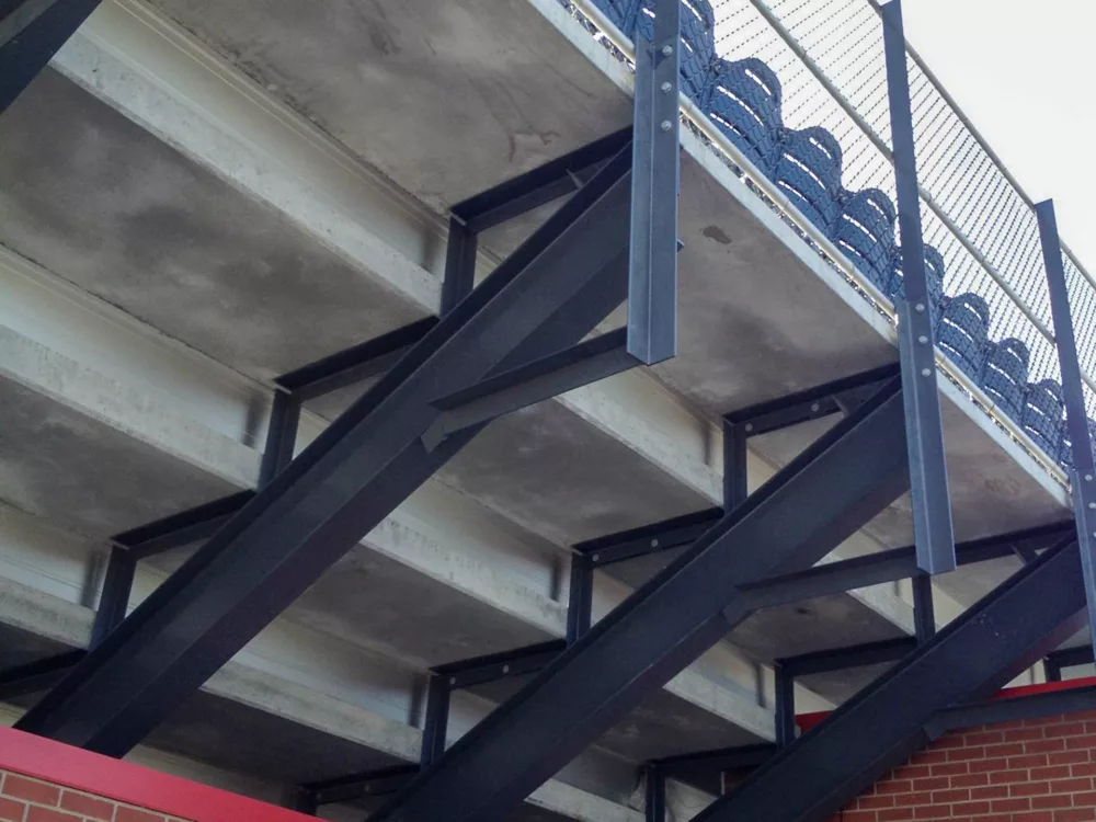 An underside view of the Hybrid Precast Stadium System - complete with concrete risers and aluminum rail.
