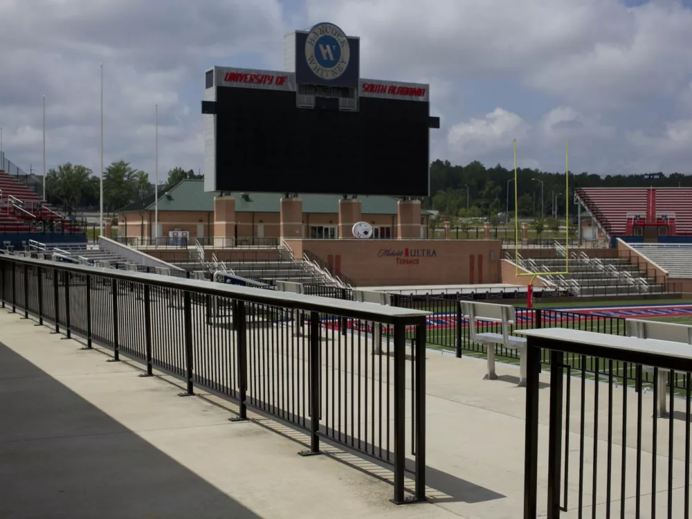Aluminum deck railing surrounds the stadium and keeps bleacher seating areas separate.