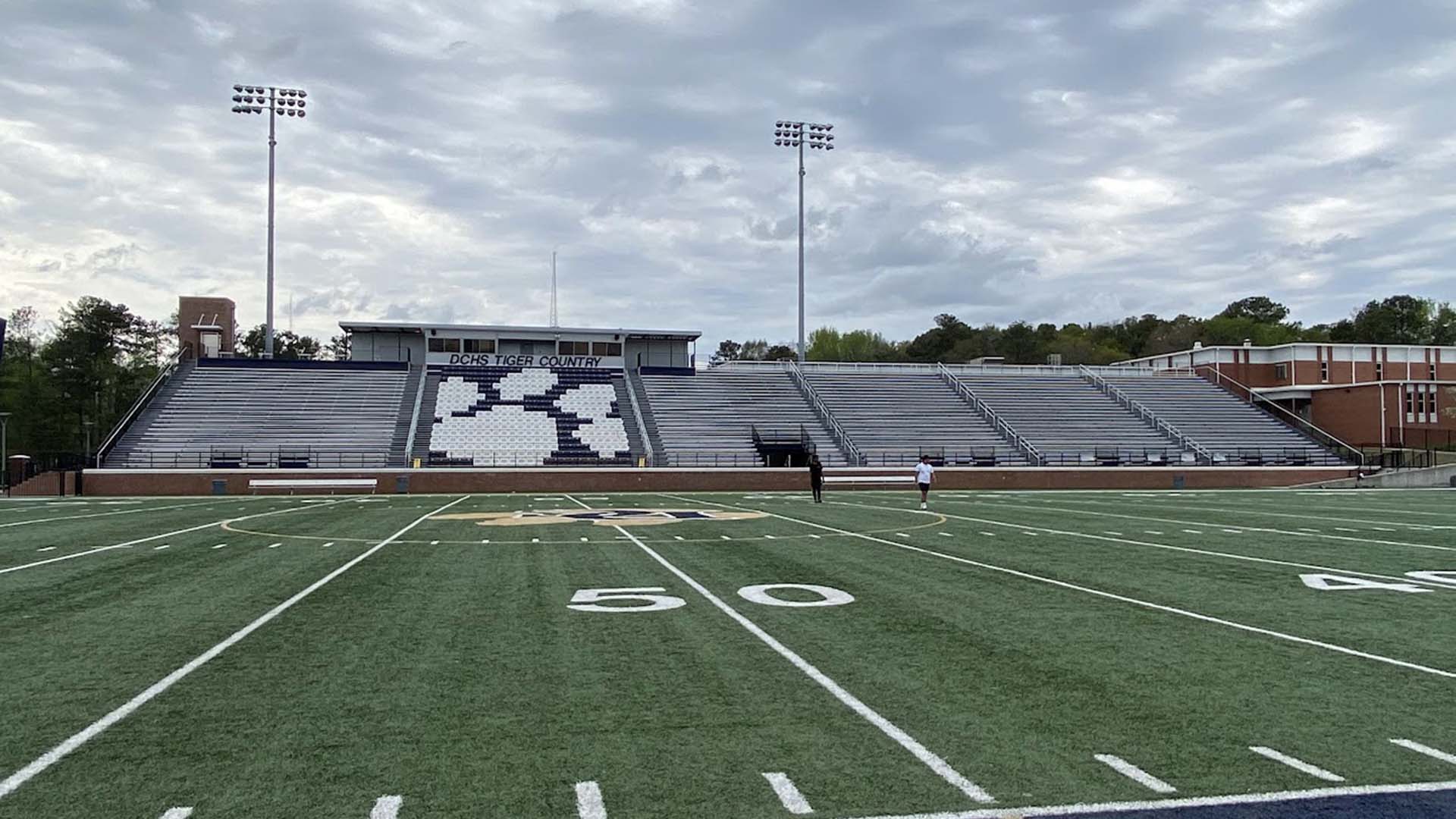 The grandstand at Doulgas County High School, featuring aluminum rail and bench seats.
