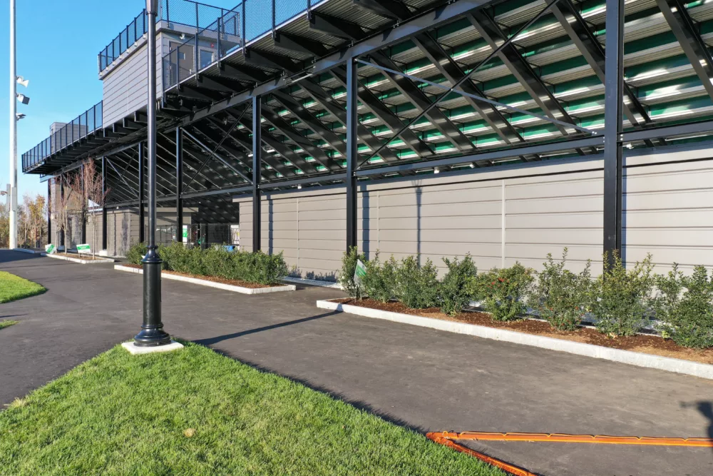 Image of rear of I-beam grandstand showing black powder coated steel and rear view of press box