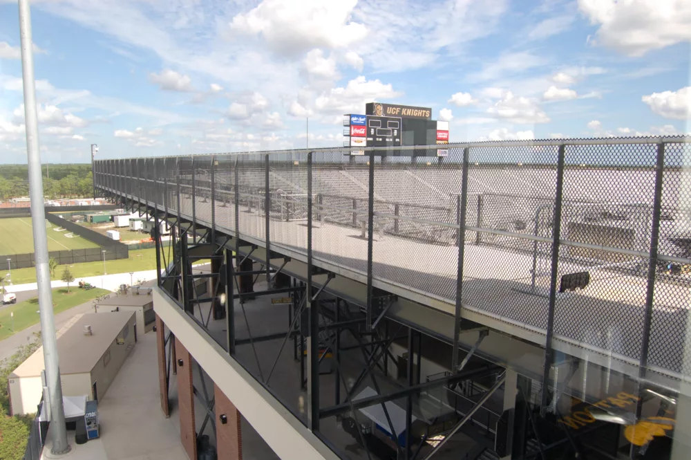 View of chain link fence around upper bowl of UCF Knights stadium in Orlando, Florida.