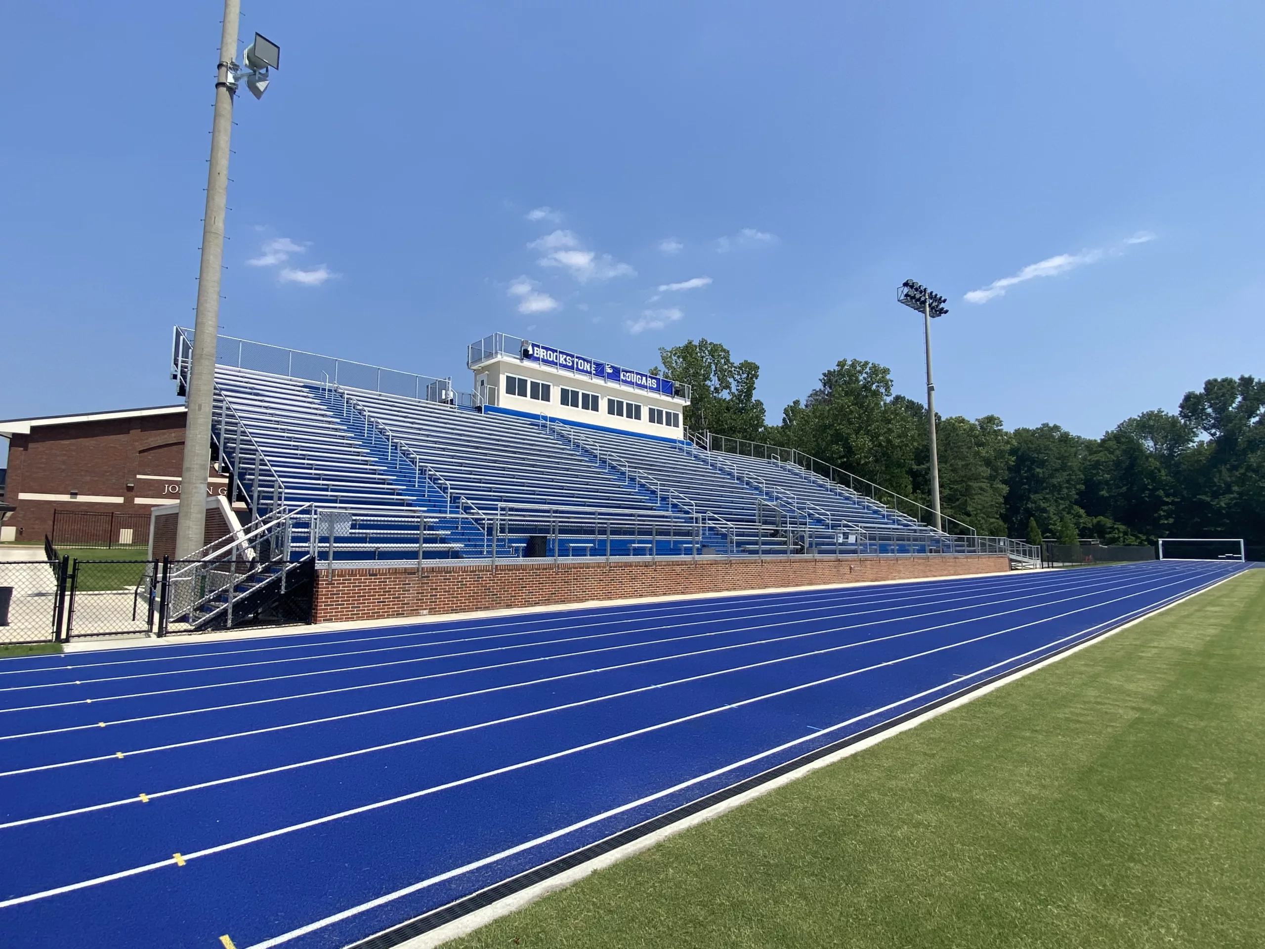 Game Ready Grandstand with press box. Blue powder coated risers to coordinate with blue track