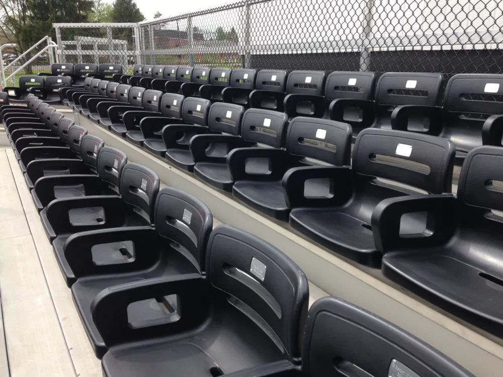 Colosseum One Vented Chairs in black on a grandstand featuring donor plates in a VIP section