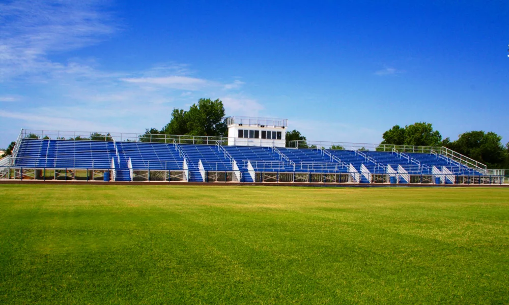 Aluminum bleacher featuring front egress stairs and press box