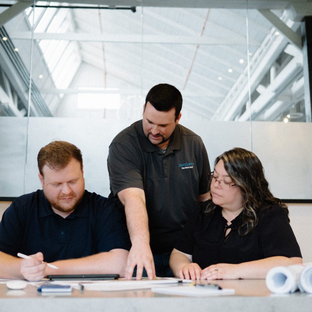 A team of Dant Clayton architects are looking over blueprints for an upcoming project.